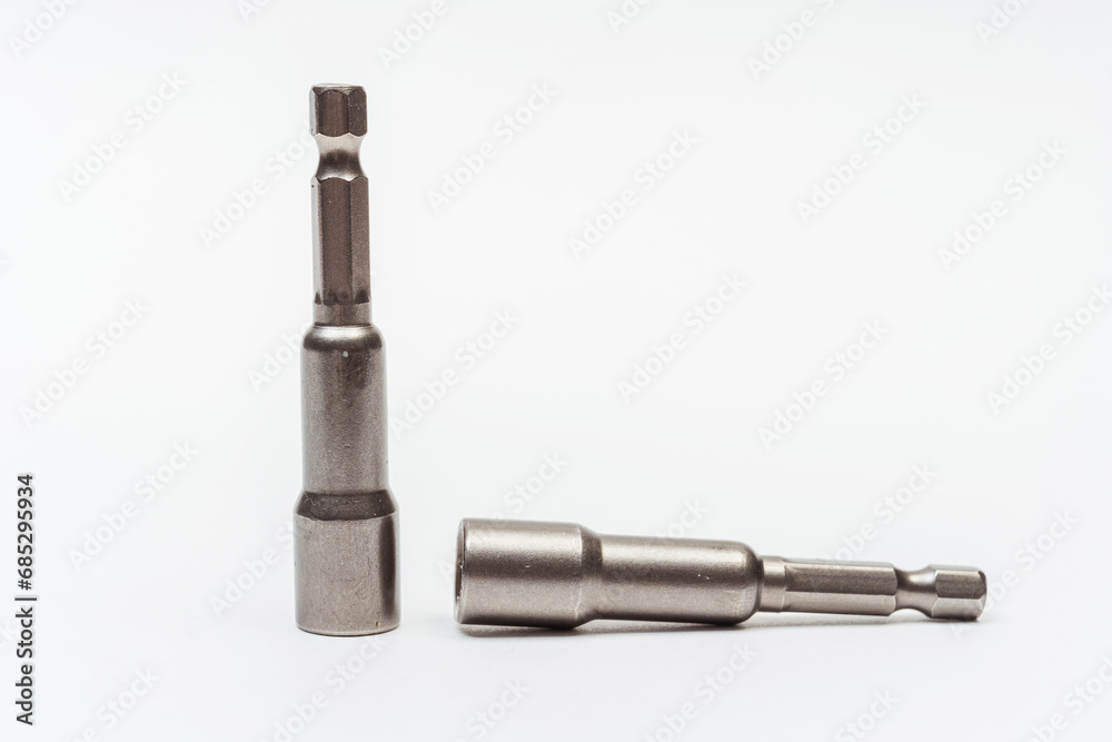 iron nozzle for roofing screws on a white background. metal adapter for screwing in self-tapping screws on a light background. reinforced bolt socket iron nozzle for roofing screws on a white background. metal adapter for screwing in self-tapping screws on a light background. reinforced bolt socket