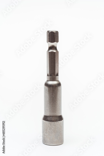 iron nozzle for roofing screws on a white background. metal adapter for screwing in self-tapping screws on a light background. reinforced bolt socket