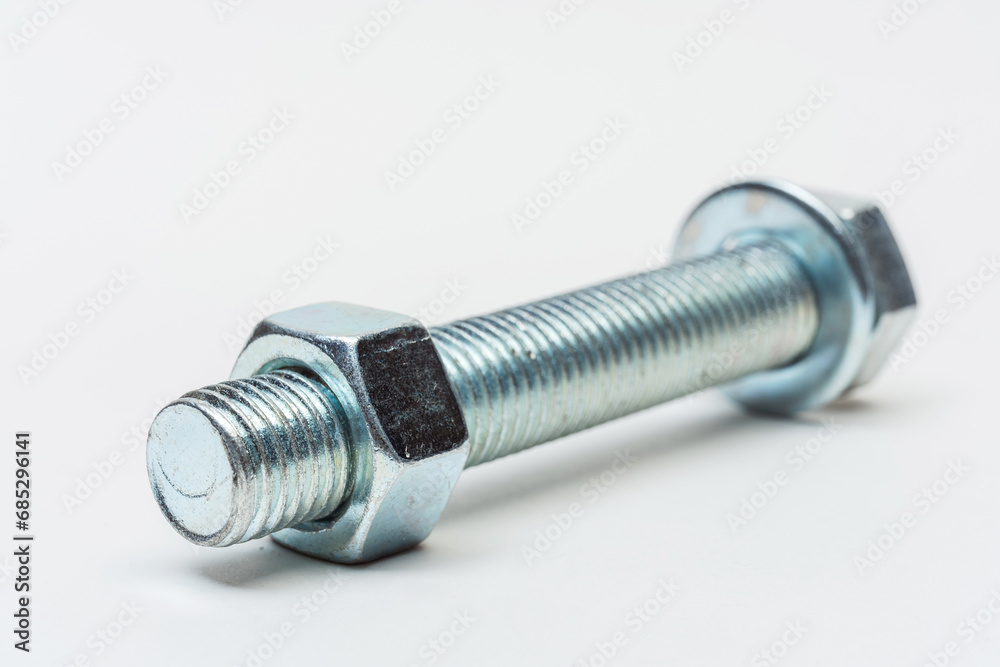 group of bolts and nuts on a white background. bolts, washers and nuts assembled on a light background. photo of fasteners with threads for the catalog group of bolts and nuts on a white background. bolts, washers and nuts assembled on a light background. photo of fasteners with threads for the catalog