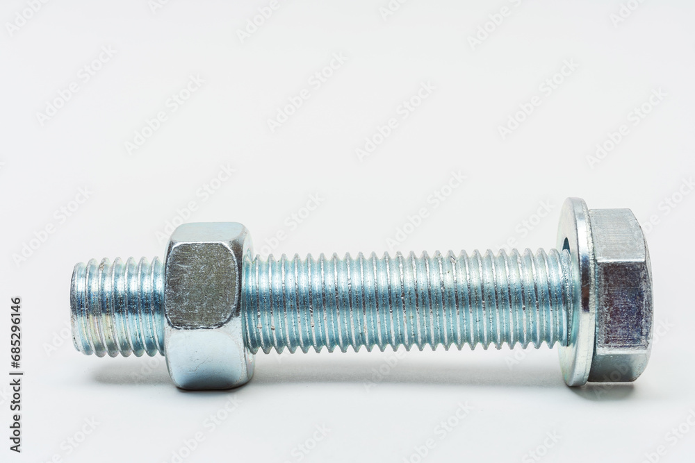 group of bolts and nuts on a white background. bolts, washers and nuts assembled on a light background. photo of fasteners with threads for the catalog group of bolts and nuts on a white background. bolts, washers and nuts assembled on a light background. photo of fasteners with threads for the catalog