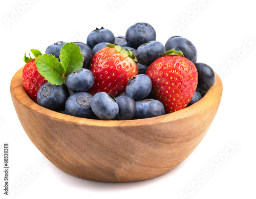 Blueberries and strawberries in wooden bowl isolated on white background