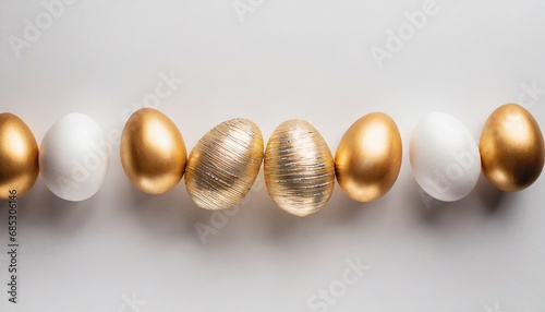 easter golden decorated eggs stand in a row on white background minimal easter concept happy easter card with copy space for text top view flatlay