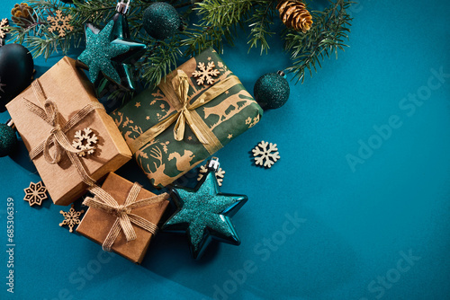 Christmas background. Gift boxes tied ribbons and christmas decorations on turquoise background.