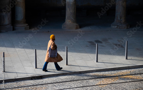Woman  walking by dark abandoned alley, alone, high angle view