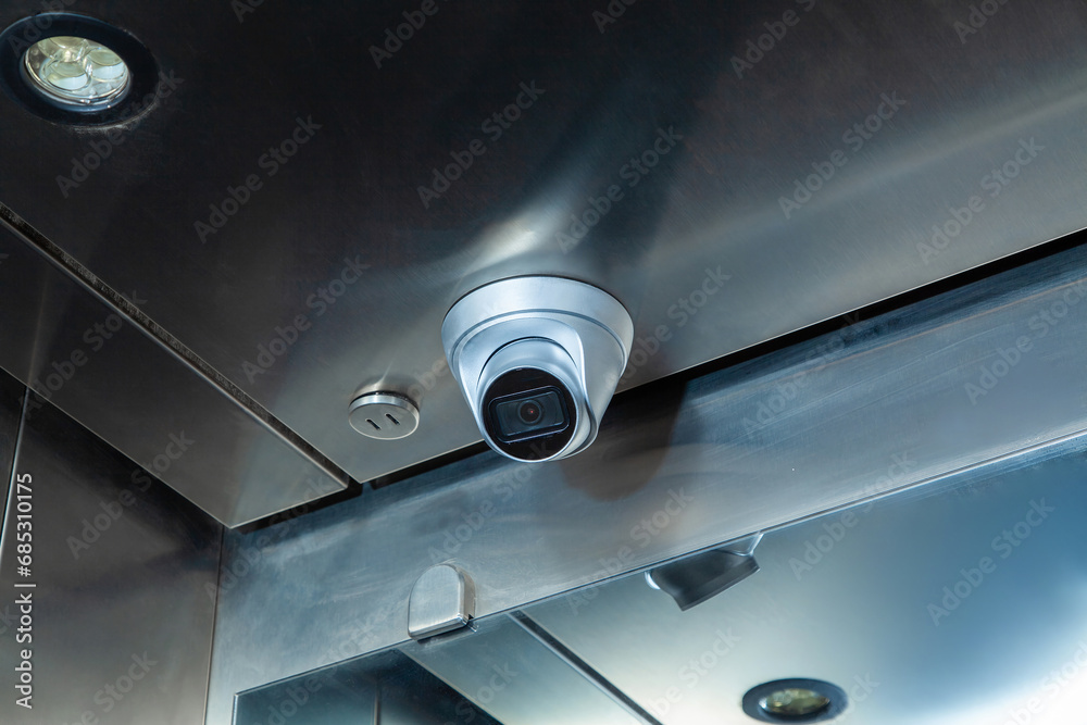 Dome security camera in the public elevator in the business center