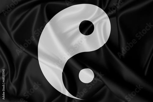 Yin Yang symbol on silk texture photo