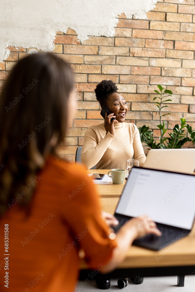 Two young business women working in the modern office Two young business women working in the modern office