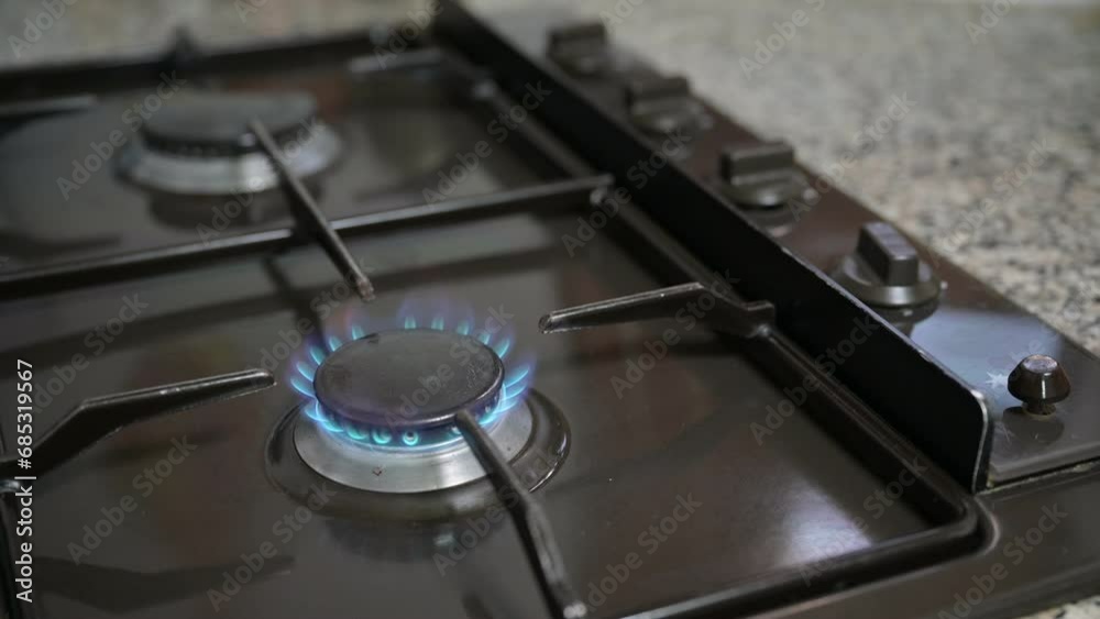 A male hand raises the kitchen gas burner and then turns off the kitchen gas burner.
A male hand raises the kitchen gas burner and then turns off the kitchen gas burner.