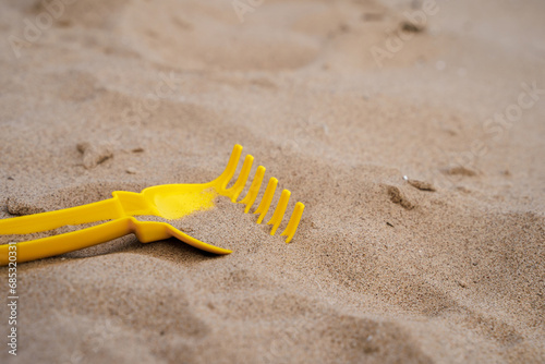Children's yellow shovel on the beach
