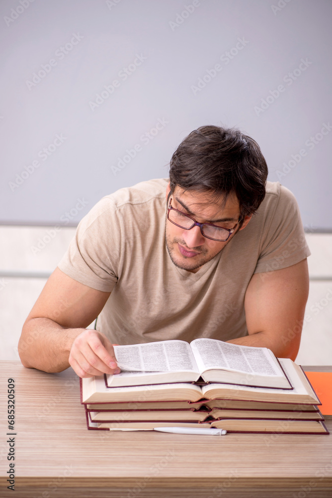 Young male student sitting in the classroom Young male student sitting in the classroom