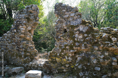 Ruins of the Great Basilica in Butrint National Park, Buthrotum, Albania. Triconch Palace at Butrint Life and death of an ancient Roman house Historical medieval Venetian Tower surrounded photo