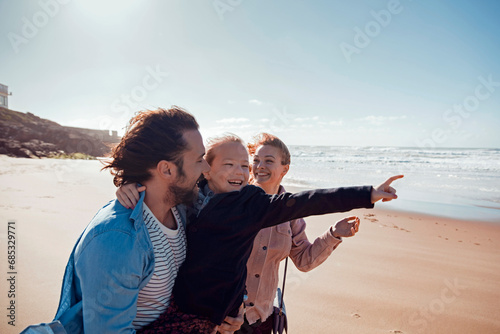 Happy family exploring the beach on vacation photo