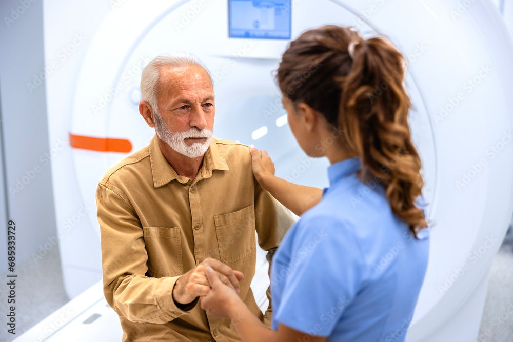 Obraz premium Nurse making senior patient comfortable before MRI scanning test procedure in hospital.
