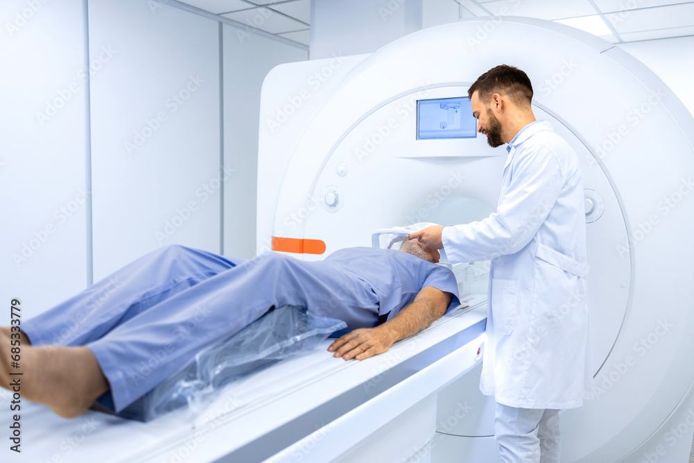 Radiologist or technician preparing senior man for complete MRI or CT head scan at oncology diagnostic center. Radiologist or technician preparing senior man for complete MRI or CT head scan at oncology diagnostic center.