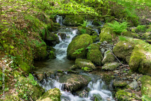 Long exposure of a waterfall flowing into the river Barle at Tarr Steps in Exmoor National Park