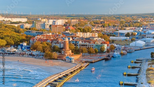 Port and lighthouse in Kołobrzeg, Poland. Photo taken with a drone at the beginning of autumn. The rippling, blue Baltic Sea.