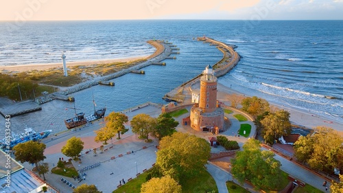 Port and lighthouse in Kołobrzeg, Poland. Photo taken with a drone at the beginning of autumn. The rippling, blue Baltic Sea. photo