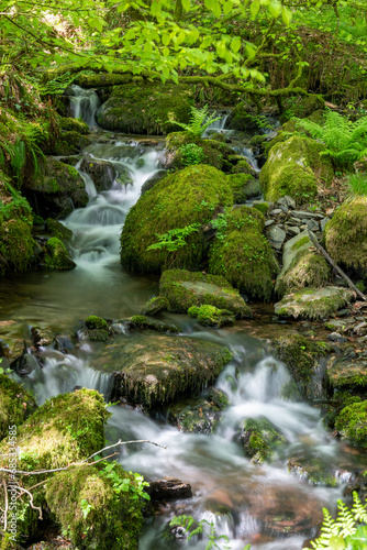 Long exposure of a waterfall flowing into the river Barle at Tarr Steps in Exmoor National Park