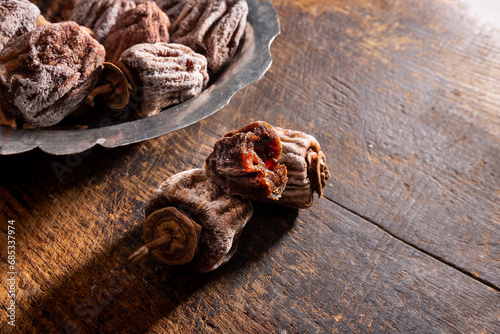 Dried persimmons on wooden table photo