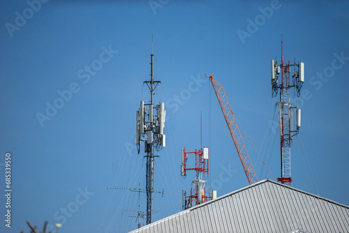 Telecommunication tower with blue sky and white clouds, technology background. photo