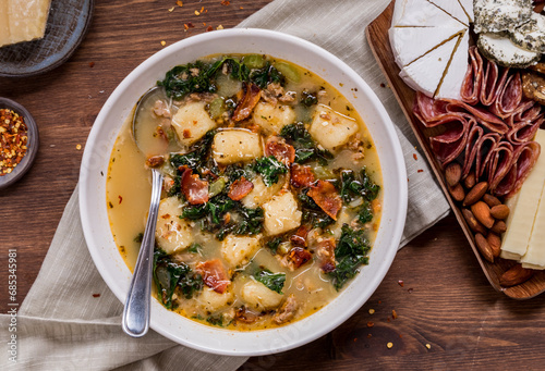 Zuppa toscana soup with cauliflower gnocchi served with deli meats and cheeses. photo
