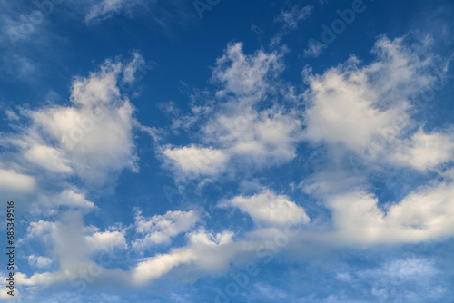 Blue sky with fluffy clouds. Abstract tranquil background