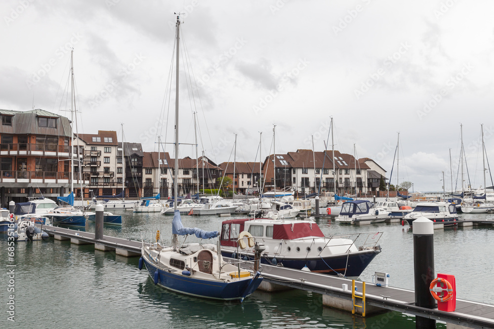 Sailing yachts and pleasure motor boats are moored in Southampton marina, UK