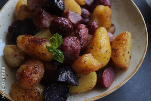 colored peeled fried potatoes close-up in clay plate selective focus