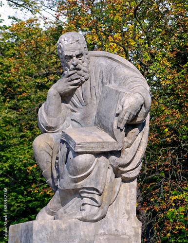 Statue of Aristophanes with an open book at the Lazienki park amphitheater in Warsaw, Poland