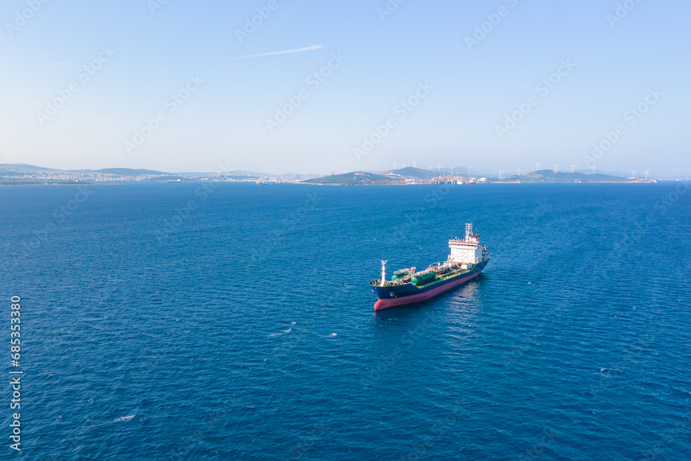 Oil chemical tankers anchored near port of oil chemical plant, aerial drone shot