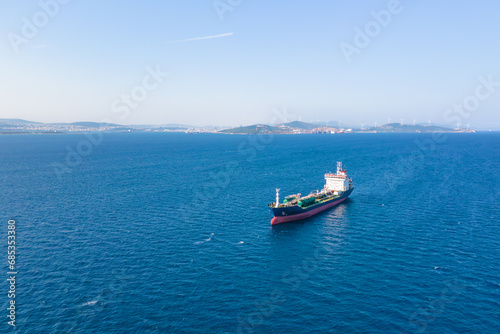 Oil chemical tankers anchored near port of oil chemical plant, aerial drone shot