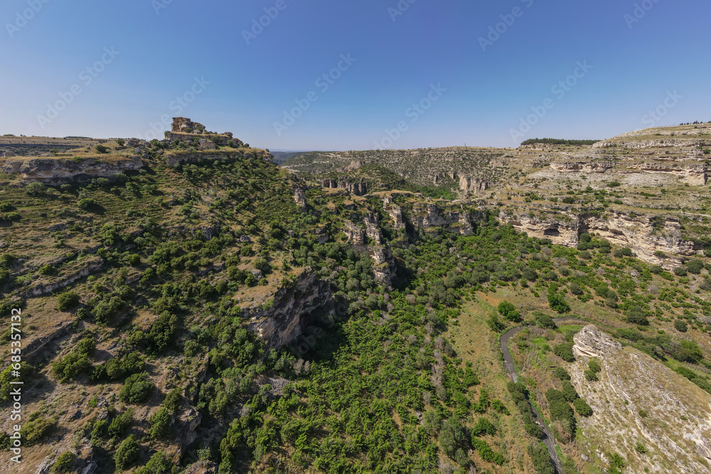 Landscape of canyon with cliff in sunny day in Turkiye. AERIAL shot