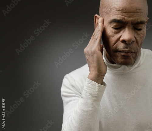 suffering from deafness and hearing loss on grey black background with people stock image stock photo © herlanzer