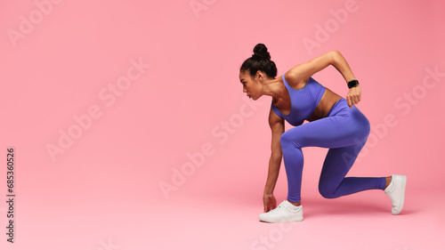 Motivated Black Lady Runner Doing Crouch Start On Pink Background