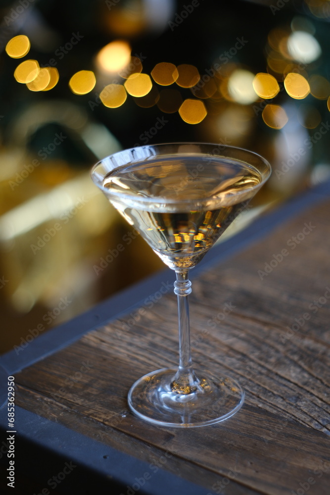 Gold Christmas background. New Year champagne and sparkling wine are pouring into a festive glass. New Year and Christmas theme.