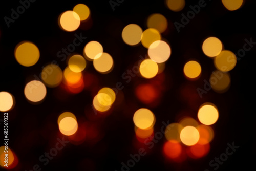 background of defocused lights on black background, gold light bokek for holiday lights background or Christmas background © Airiny