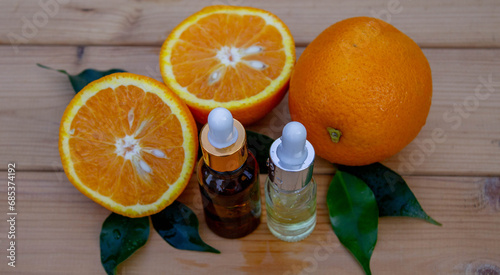 Fototapeta Naklejka Na Ścianę i Meble -  Essential extract of orange oil in a small bottle. Selective focus.