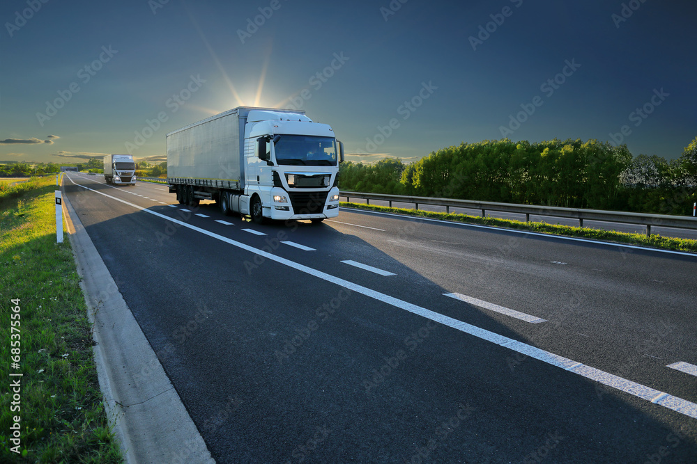 Large Transportation Truck on a highway road through the countryside 