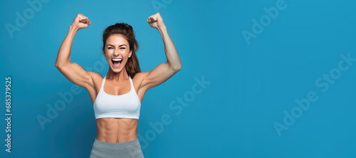 Healthy Strong Woman Fitness Model on a Blue Background with Space for Copy photo