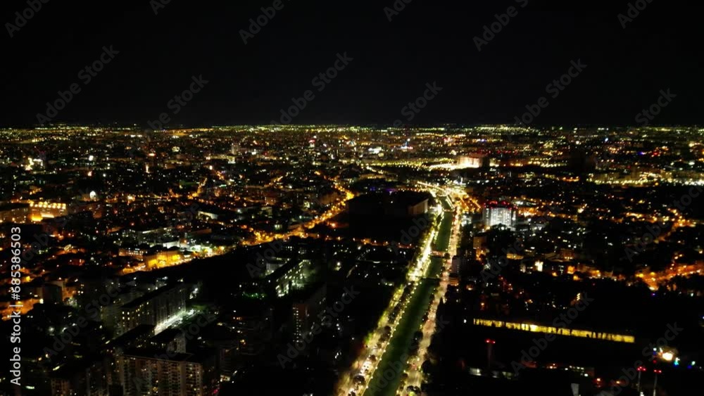 High angle drone night cityscape of Bucharest Romania. Night flyover shot of illuminated european city. Night cityscape from up above. Beautiful night lights of a bug urban area. Establishing shot.
High angle drone night cityscape of Bucharest Romania. Night flyover shot of illuminated european city. Night cityscape from up above. Beautiful night lights of a bug urban area. Establishing shot.