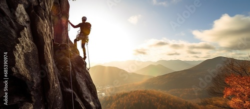 Young man doing rock climbing in the mountains