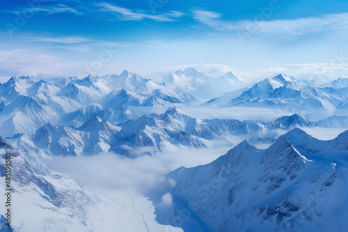 A snowy mountain range seen from a bird's eye view, showcasing the pristine beauty of snow-covered peaks and valleys.