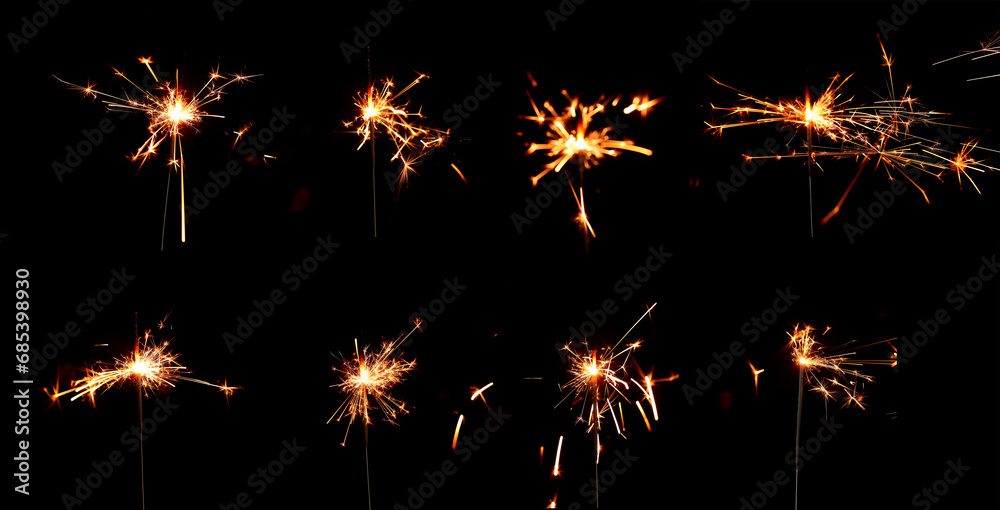 Many Christmas sparklers on dark background