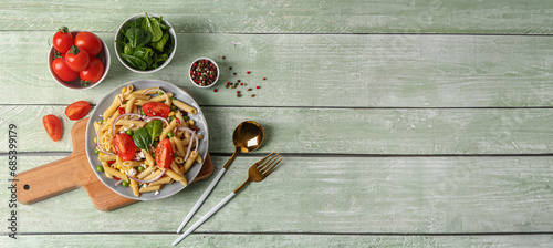 Bowl with tasty pasta salad on wooden background with space for text