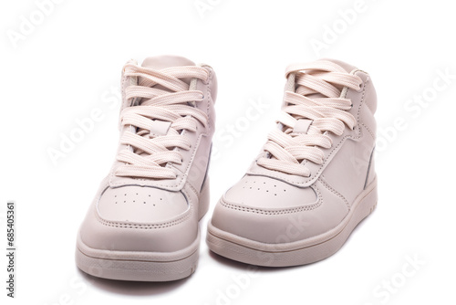 Sports leather shoes in cream color with soft soles. Casual sneakers with laces.