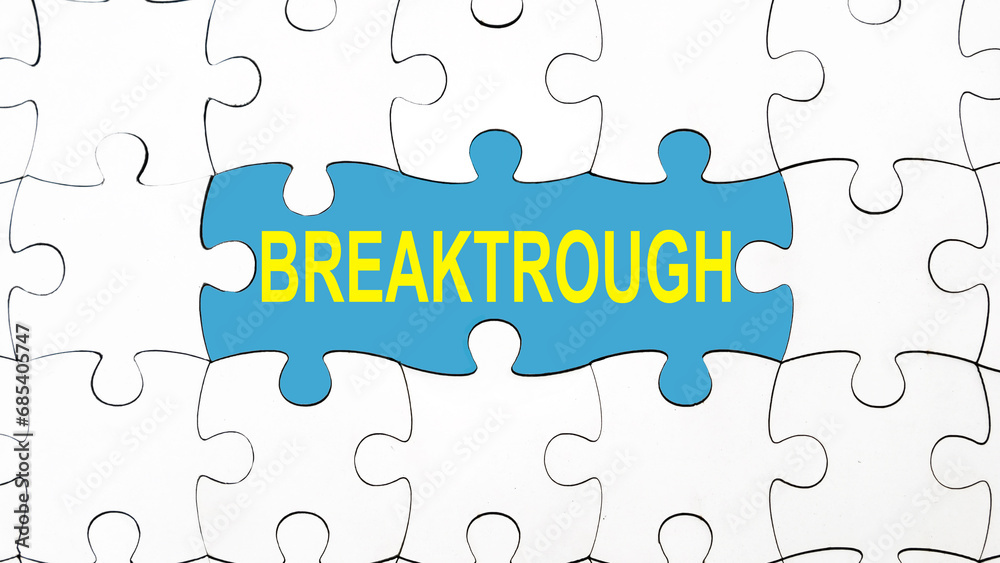 Breaktrough text under jigsaw puzzle, life and business improvement Breaktrough text under jigsaw puzzle, life and business improvement