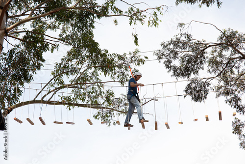 Person popping tree on ropes course