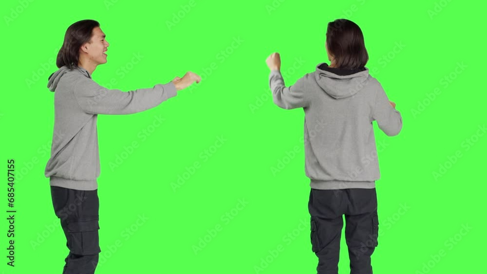 Asian man being choir chief director at musical show, moving hands like a choirmaster over greenscreen background. Young model conducting band to sing, smiling conductor bandmaster. Asian man being choir chief director at musical show, moving hands like a choirmaster over greenscreen background. Young model conducting band to sing, smiling conductor bandmaster.