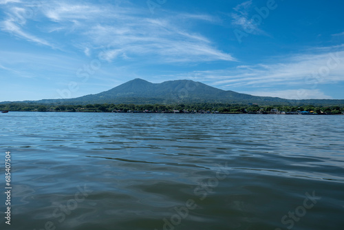 Coastline Seen From Afar with a Volcanic Mountain, Lush Vegetation Forest, Beach and Houses with a Calm Ocean