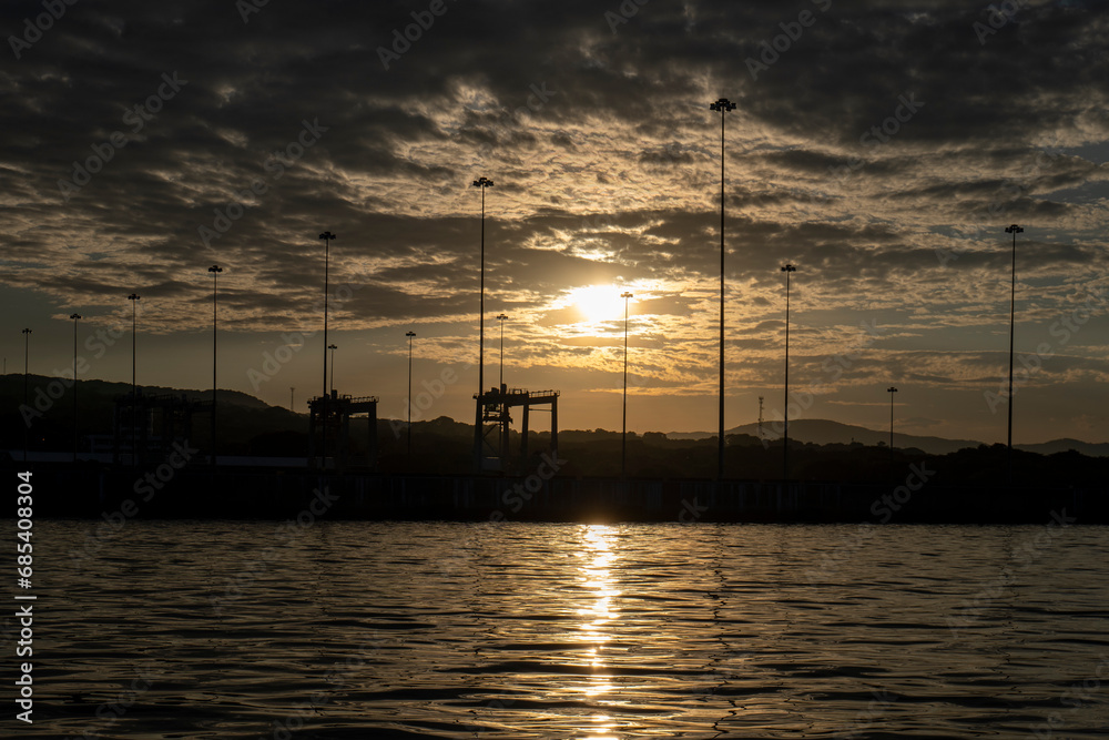 Golden Dramatic Sky with Silhouettes of Poles, Sunset in the Port of La Union in Salvador
